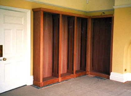 Built-in timber storage following the corner of a room.