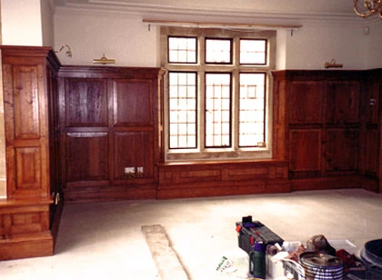 Wall panelling, fitted cabinetry and a timber window.