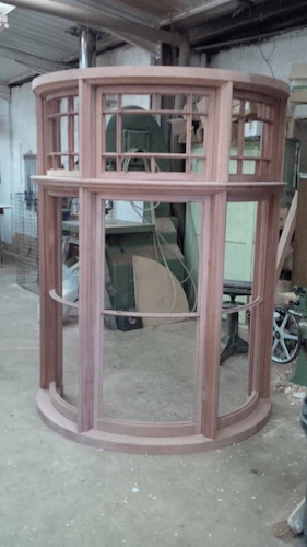 A curved window frame in the workshop.