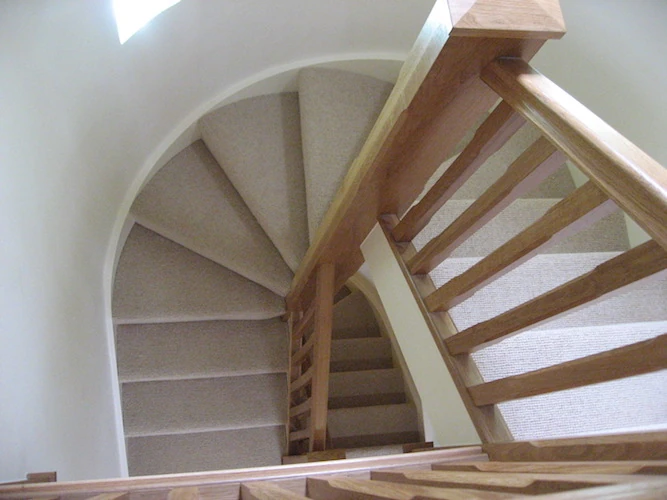 A winding timber staircase and handrail.